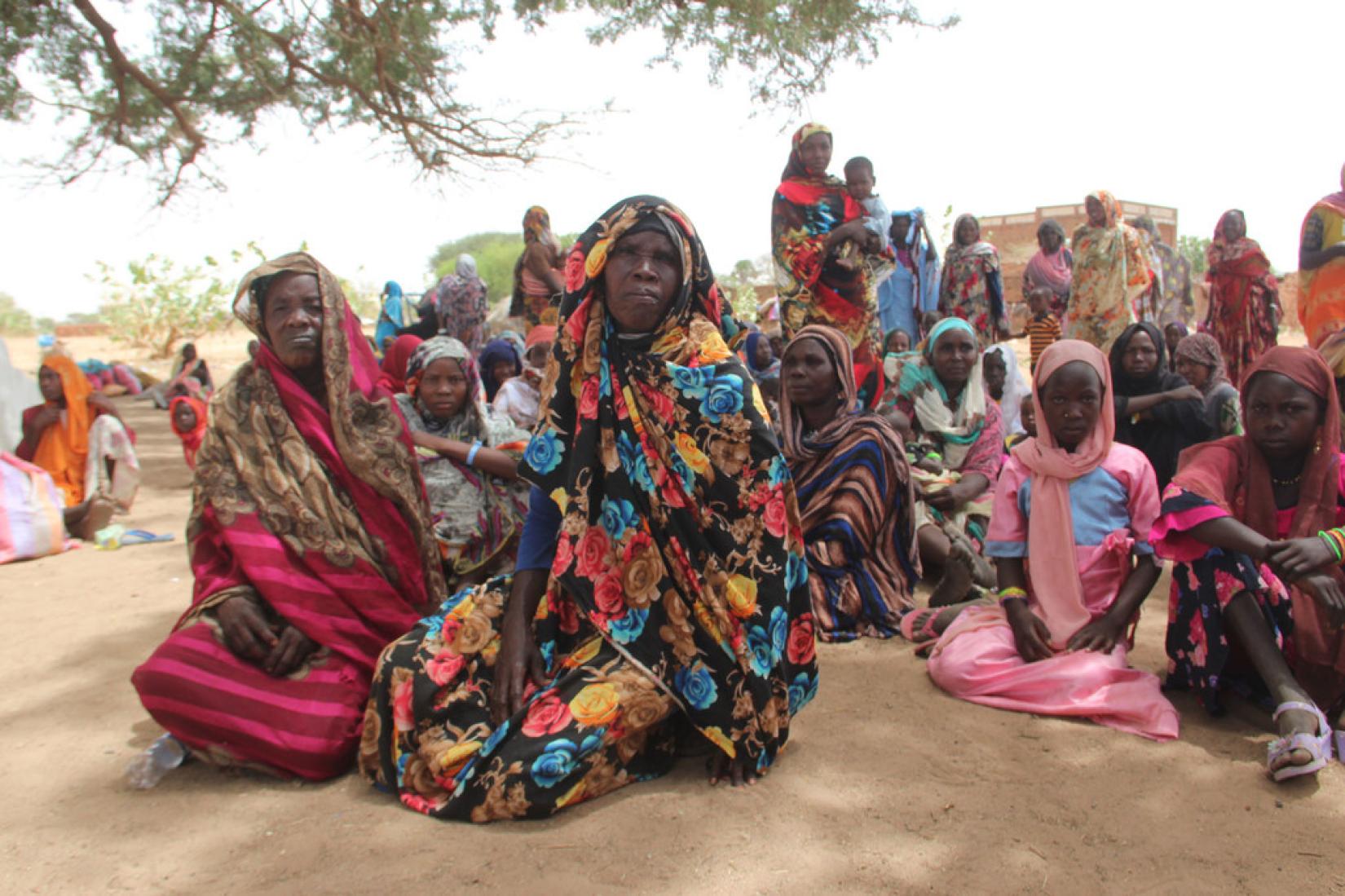 Women and children rest after crossing into Koufroun, a Chadian village situated on the Chad-Sudan border.