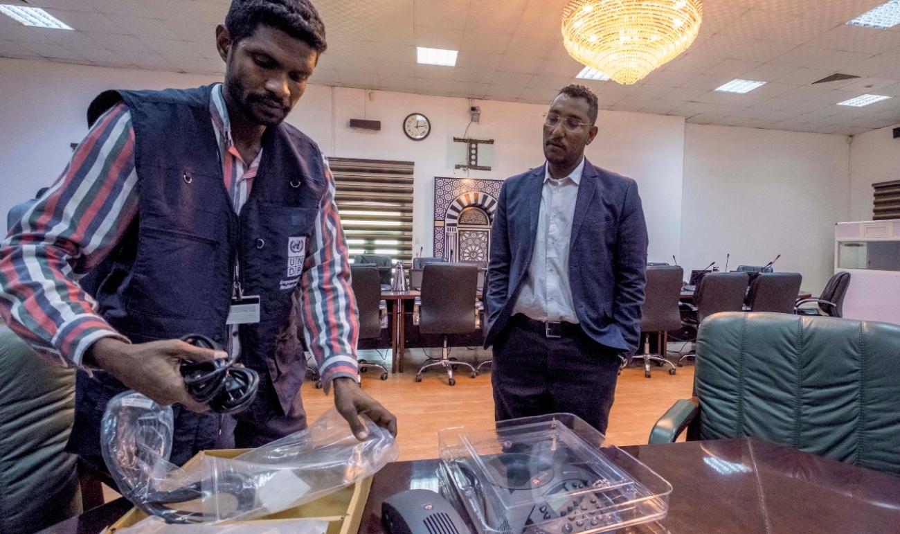 UNDP staff setting up tele-conferencing technology in Sudan's government offices, to enable staff to stay connected remotely and minimize contact.