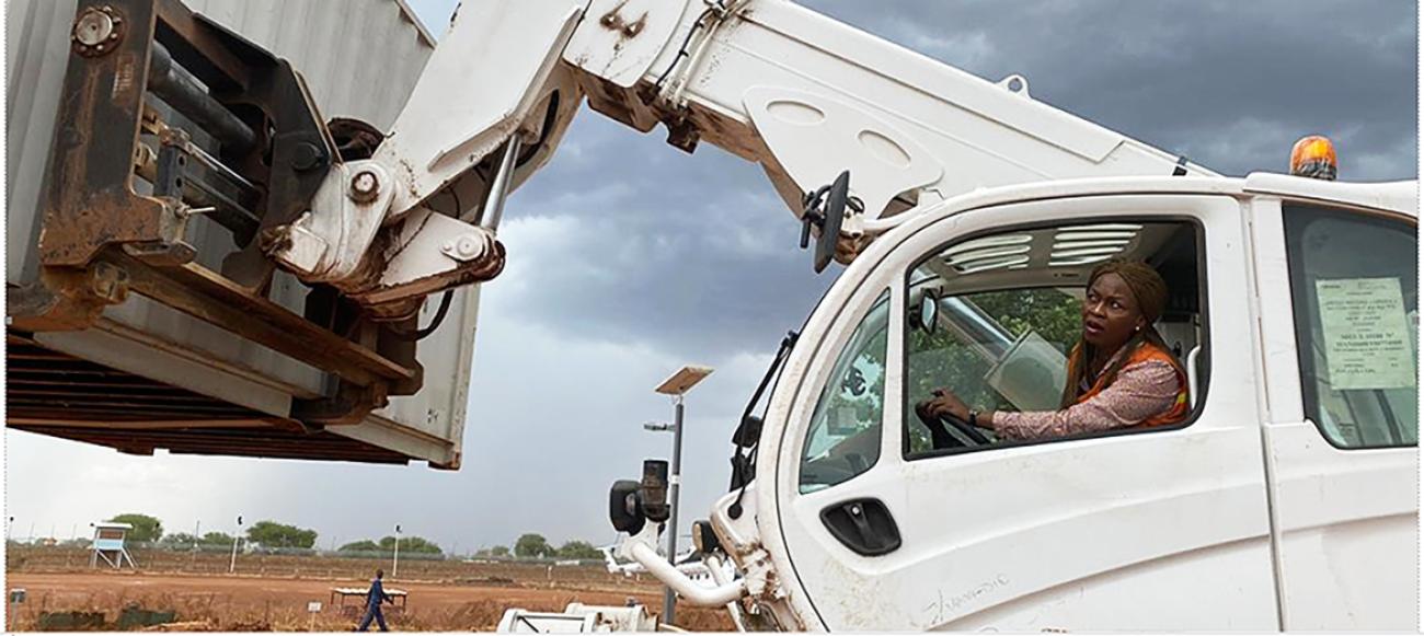  Yolanda Sibiya, UN Volunteer Movement Control Assistant with UNISFA, handling a shipping container in Abyei, Sudan. UNV, 2020