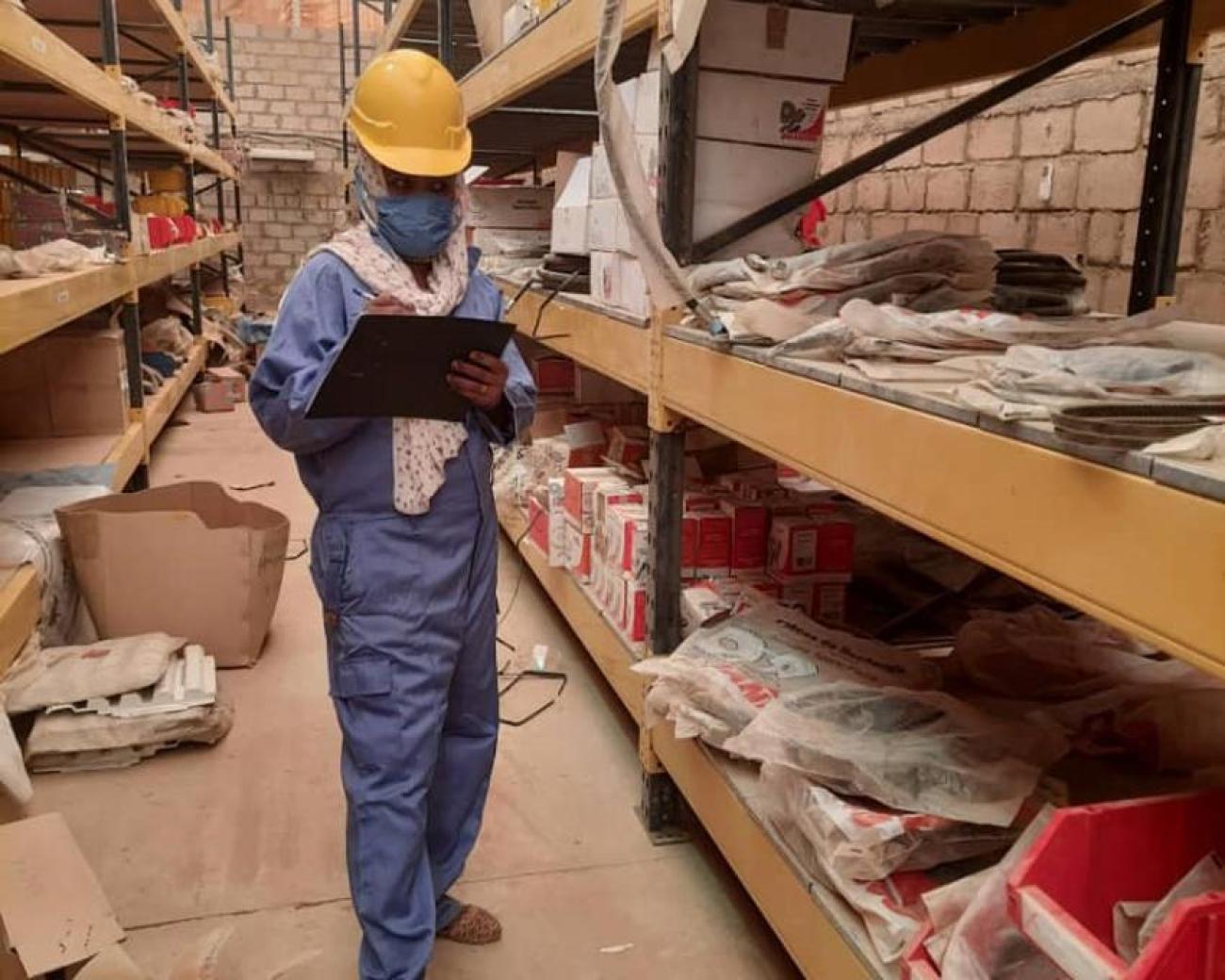 Ekram Fator, UN Volunteer Warehouse Assistant, checking fast moving spare parts in El-Fasher, Sudan.