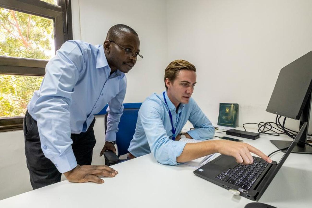 UN Volunteers Godfrey Mukalazi (left) and Kyle Jacque (right) consulting on activities for the project to Support the Sudanese Peace Process