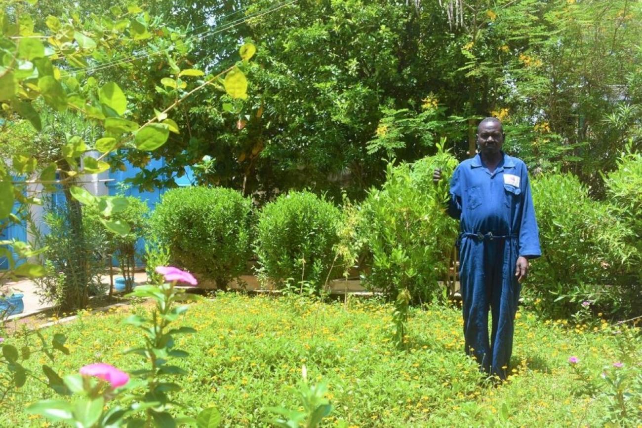 Mukhtar Ahmed stands in the garden he tends at UNHCR’s field office in El Geneina, West Darfur