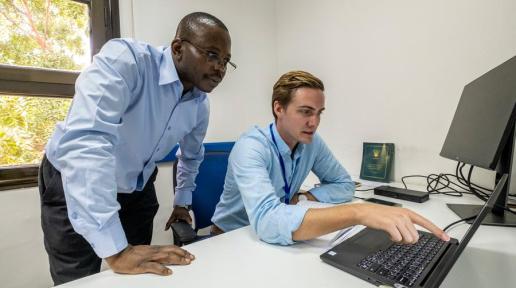 UN Volunteers Godfrey Mukalazi (left) and Kyle Jacque (right) consulting on activities for the project to Support the Sudanese Peace Process